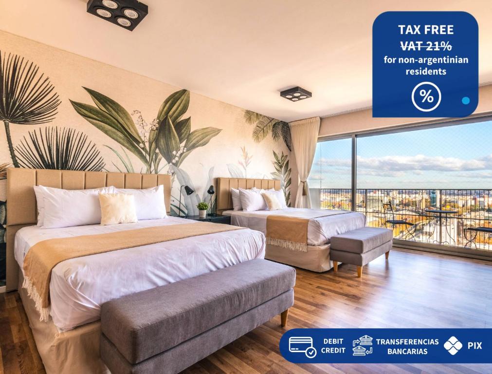 two beds in a hotel room with a sign that reads tax free wifi at Trendy Apartment in Puerto Madero in Buenos Aires