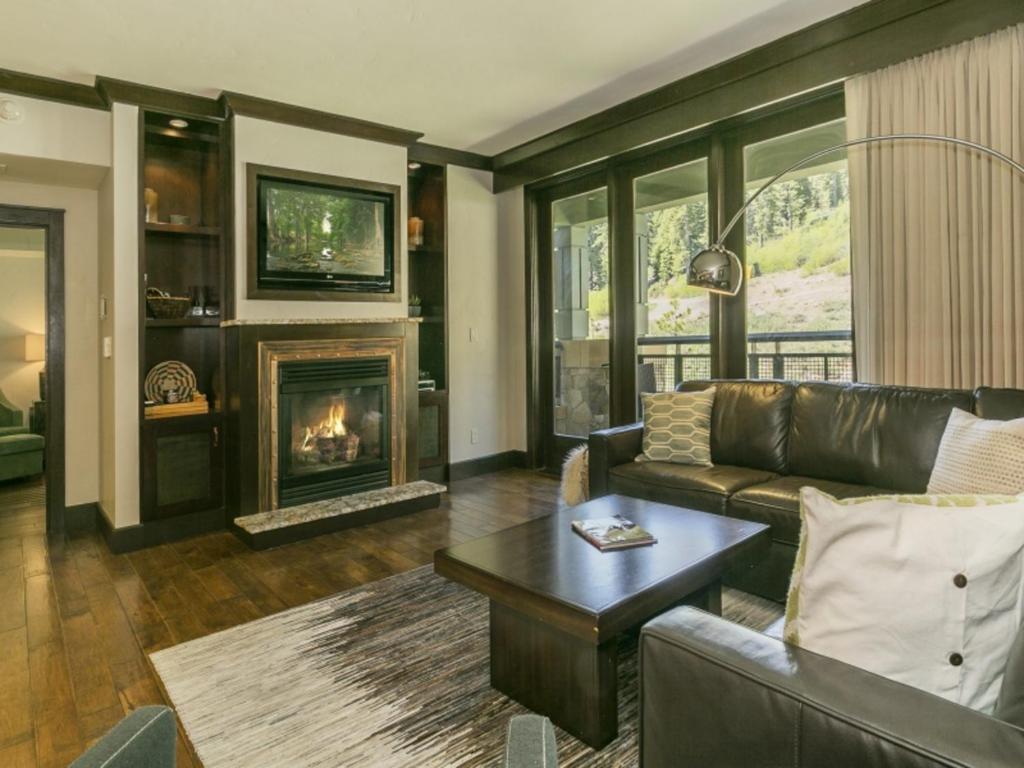 a living room with a couch and a fireplace at Constellation Residences in Truckee