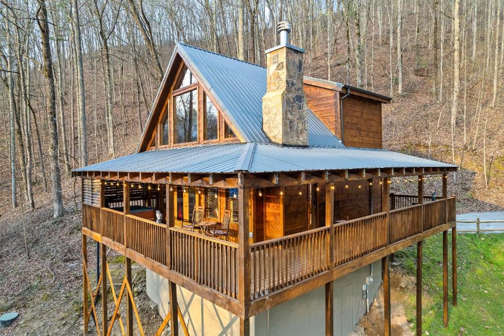a house in the woods with a tower on top at Private! Hot Tub, Views, & Games in Sevierville