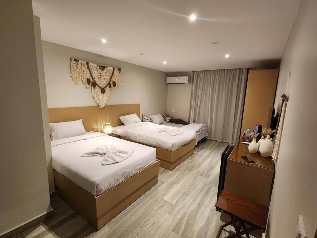 Postel nebo postele na pokoji v ubytování Diyar Pyramids Inn