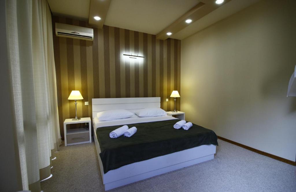 Postel nebo postele na pokoji v ubytování Sani Hotel
