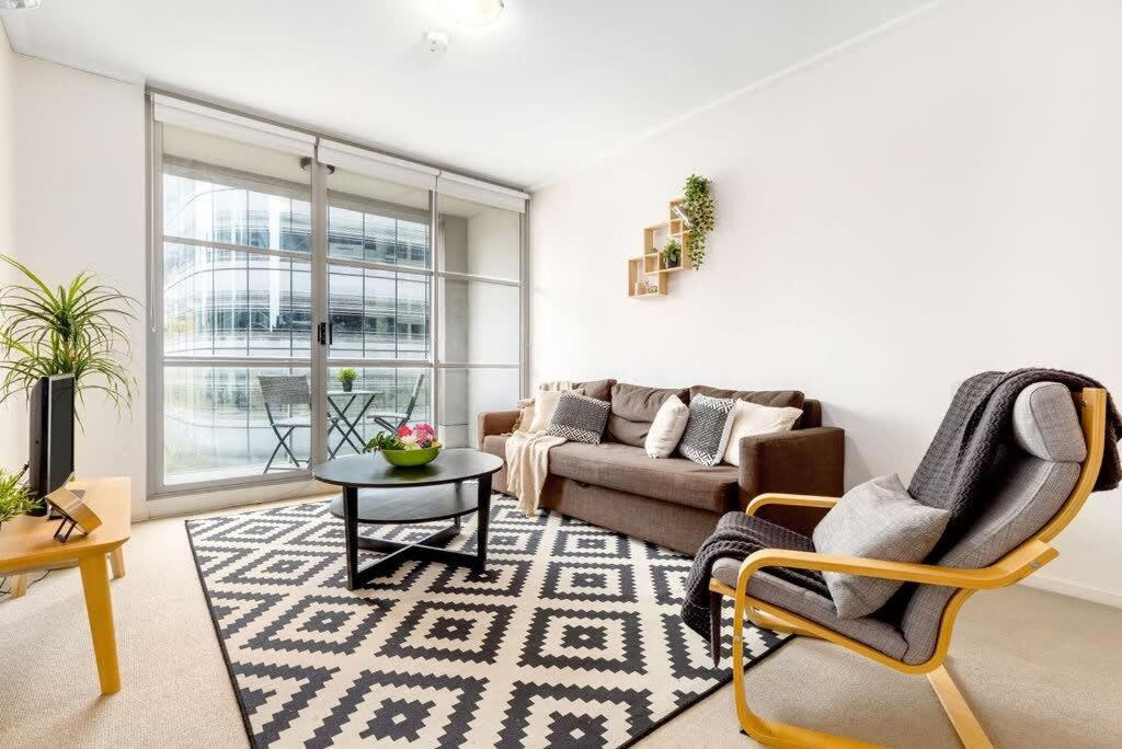 a living room with a couch and a table at A Cozy Studio CBD Next to Darling Harbour in Sydney