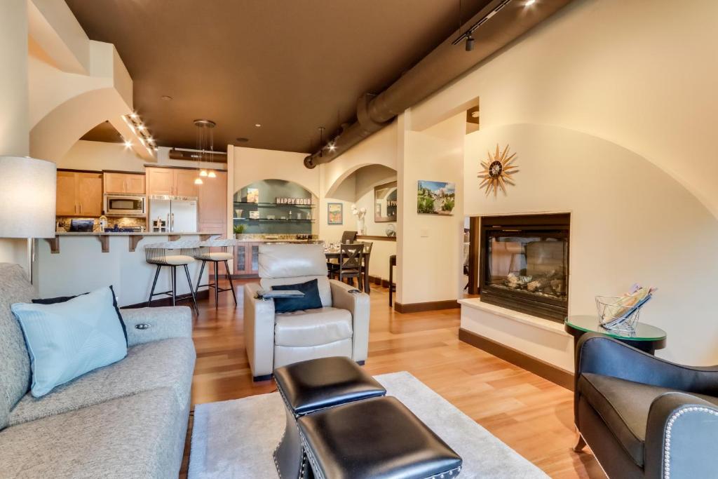 a living room with a couch and a fireplace at Stunning Coeur dAlene Condo Walk Downtown in Coeur d'Alene