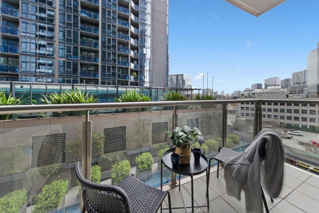 a balcony with a table and chairs on a balcony at A Large 2BR Apt Near Crown Sleeps 8 FREE Parking in Melbourne