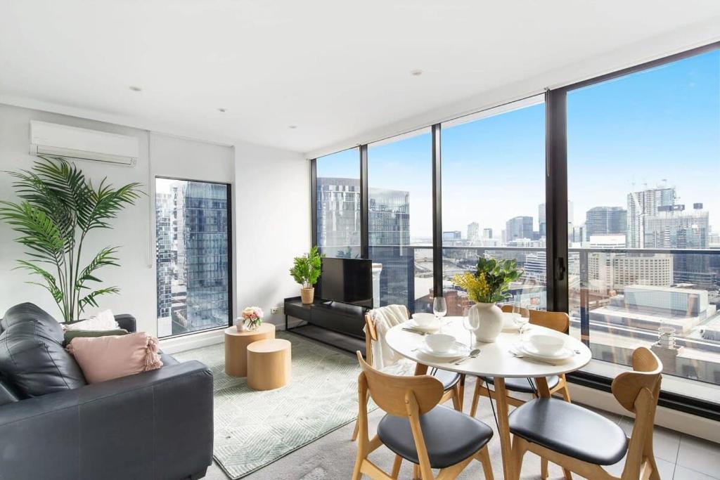 a living room with a table and a couch at An Amazing 2BR Apt with City Views in Southbank in Melbourne