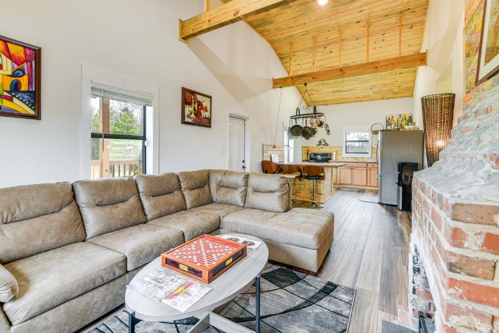 a living room with a couch and a table at Abbeville Cabin on 450 Acres Near Lake Eufaula! in Abbeville