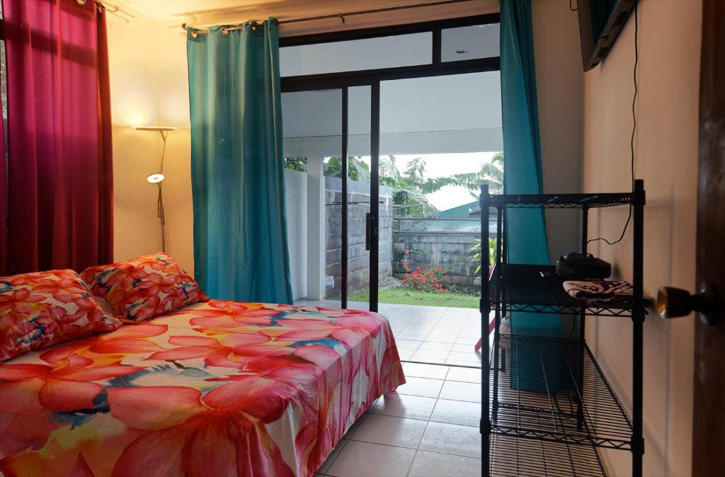 烏圖羅阿的住宿－A TOMO MAI，一间卧室设有一张床和一个滑动玻璃门