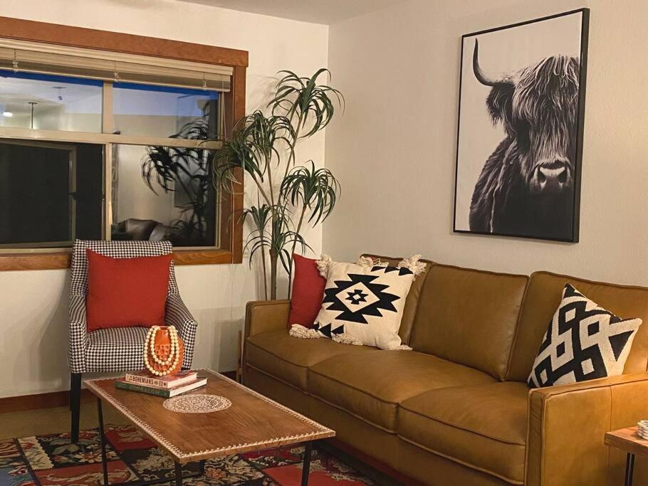 a living room with a couch and a bull on the wall at Ski In-Out Hot Tub Gym Sauna Pool Reserved Parking -501 in Brighton