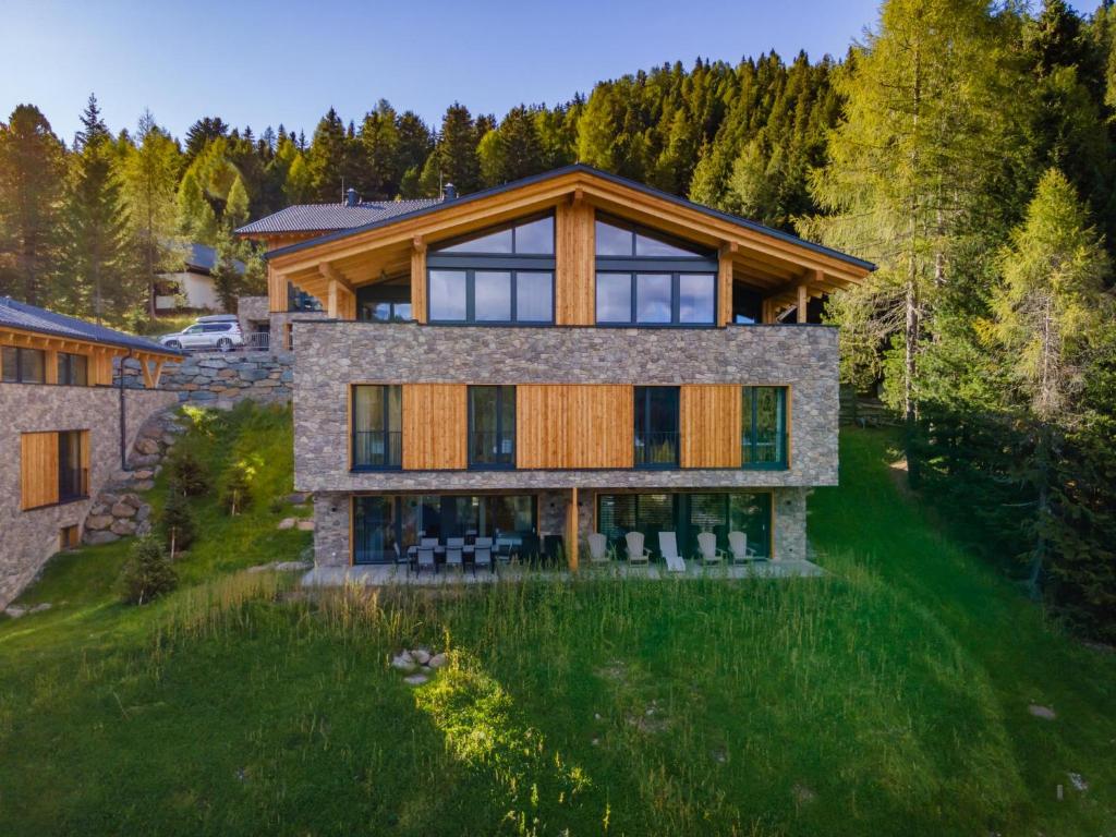 an aerial view of a house with a forest at Ibex panorama Lodge in Turracher Hohe