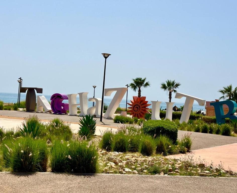 a large sign in front of the beach at Rest, sea and sun in Agadir