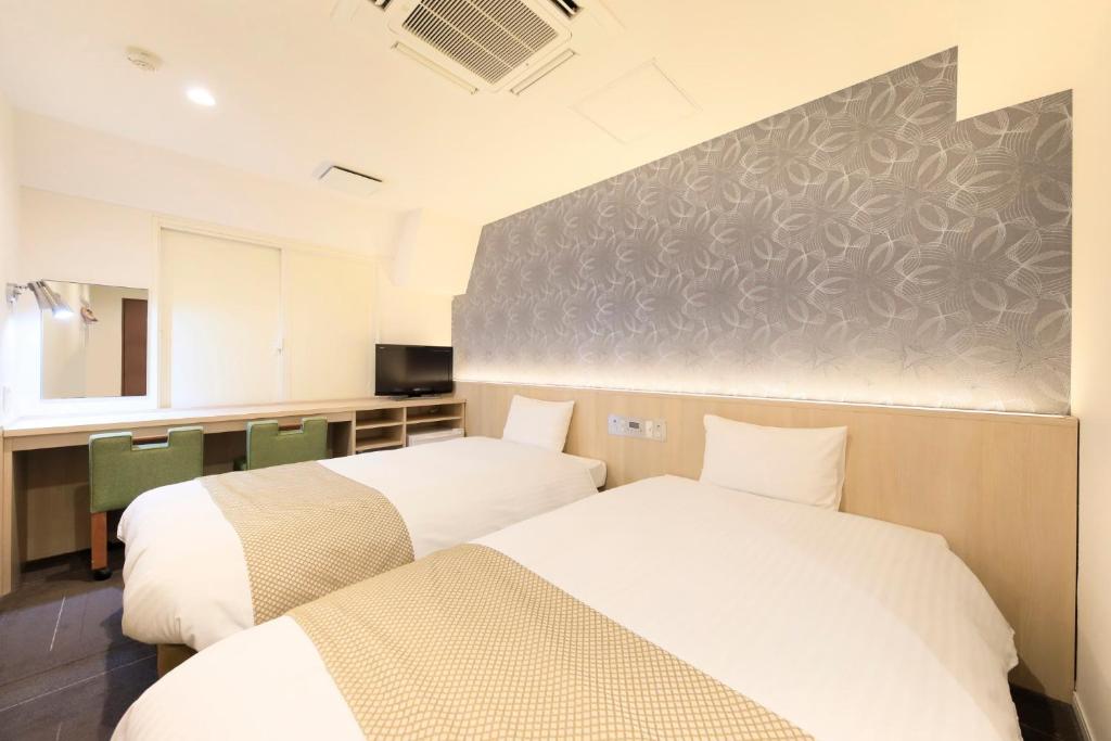 Postel nebo postele na pokoji v ubytování Hotel Shinjukuya