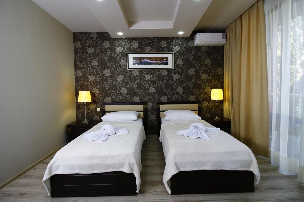 Postel nebo postele na pokoji v ubytování Sani Hotel