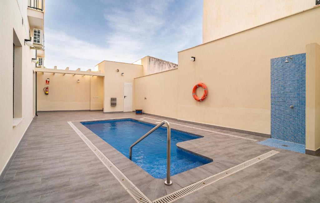 1 Bedroom Beautiful Apartment In Fuente De Piedra في فوينتيه دي بيدرا: مسبح وسط مبنى