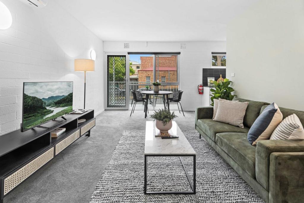 a living room with a couch and a table at Stunning 1-Bed Ground Floor Unit with Front Yard in Melbourne