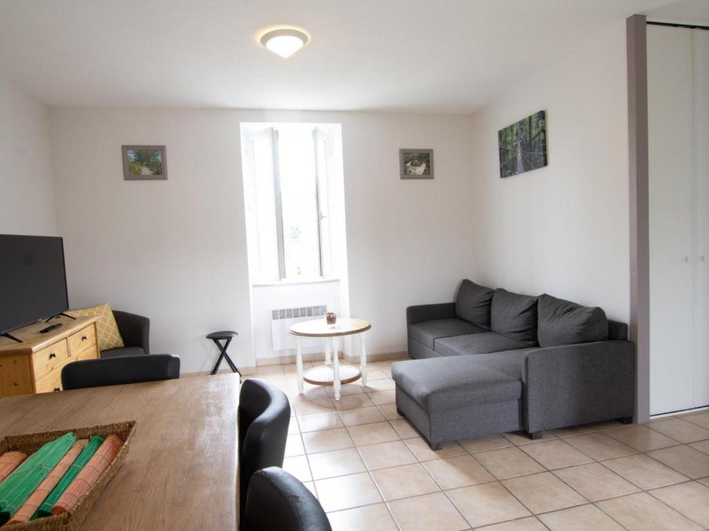 a living room with a couch and a table at Appartement Saint-Mesmin, 3 pièces, 5 personnes - FR-1-616-213 in Saint-Mesmin