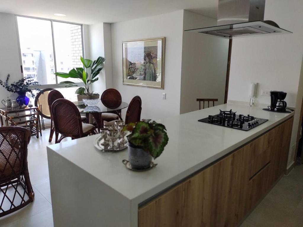 a kitchen with a white counter top and a stove at HABITACION NOVA CONDOMINIO PLUS CALI in Cali