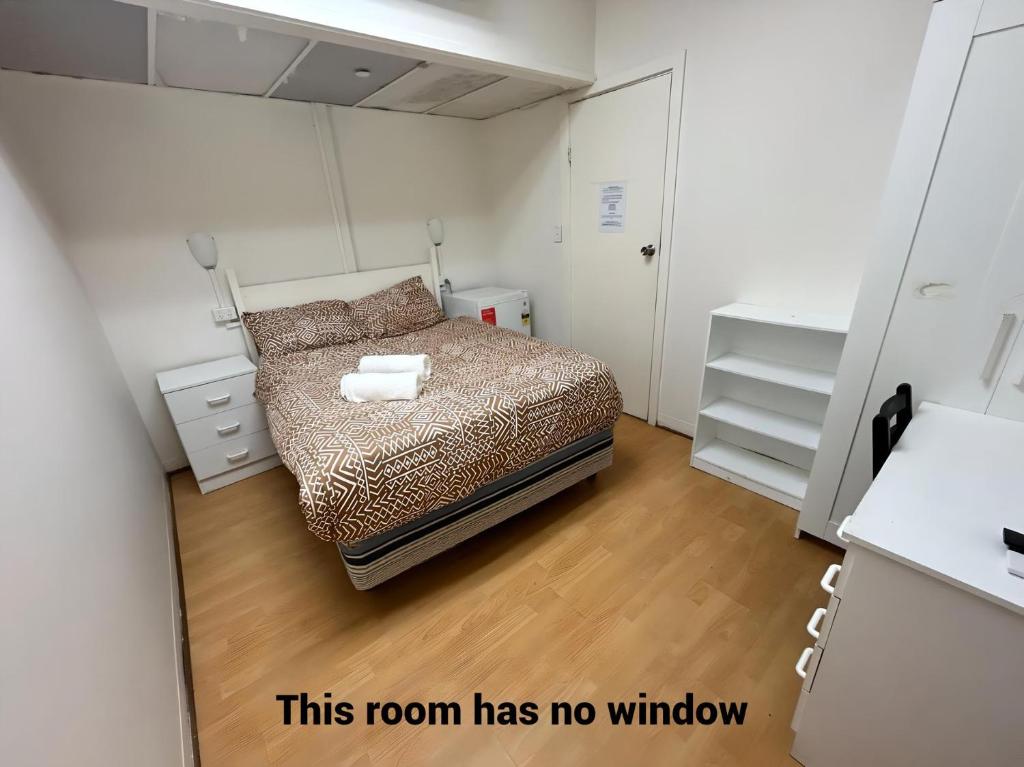 een kamer met een bed en een kamer zonder raam bij Studio 9 - Wright Lodge in Adelaide