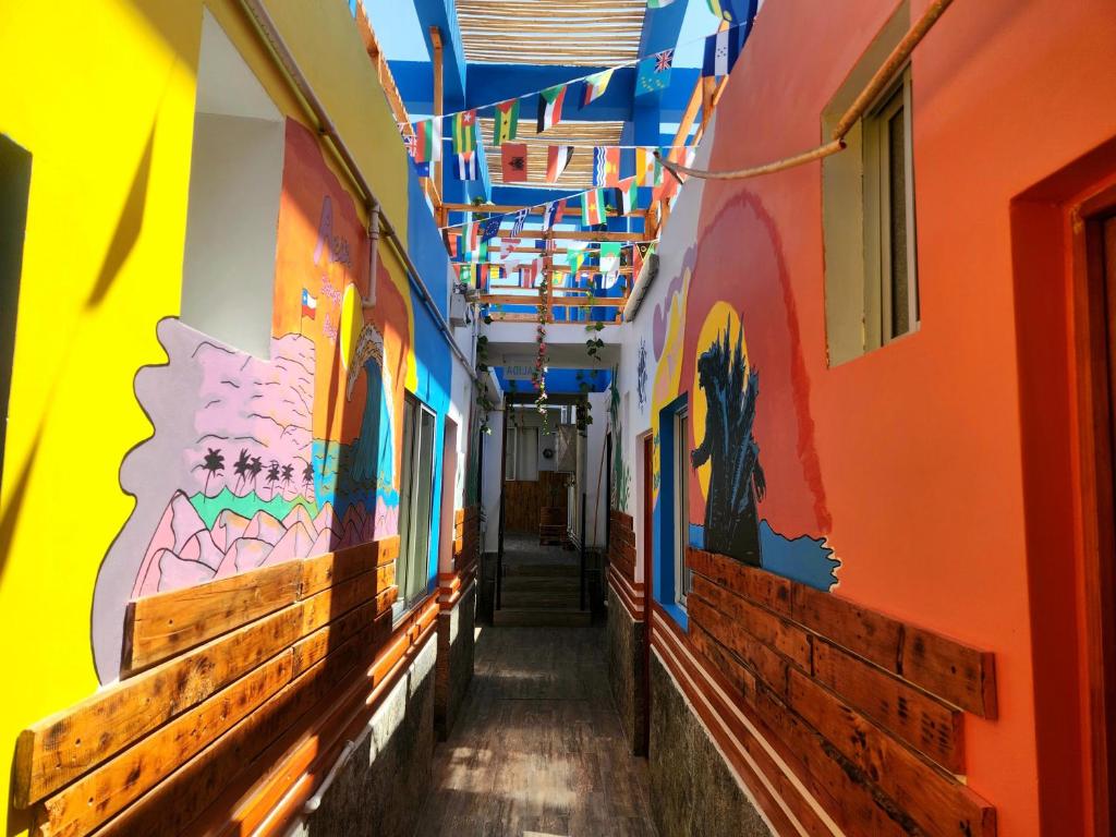 a hallway with brightly colored walls and ceilings at Raymi House Hostel in Arica