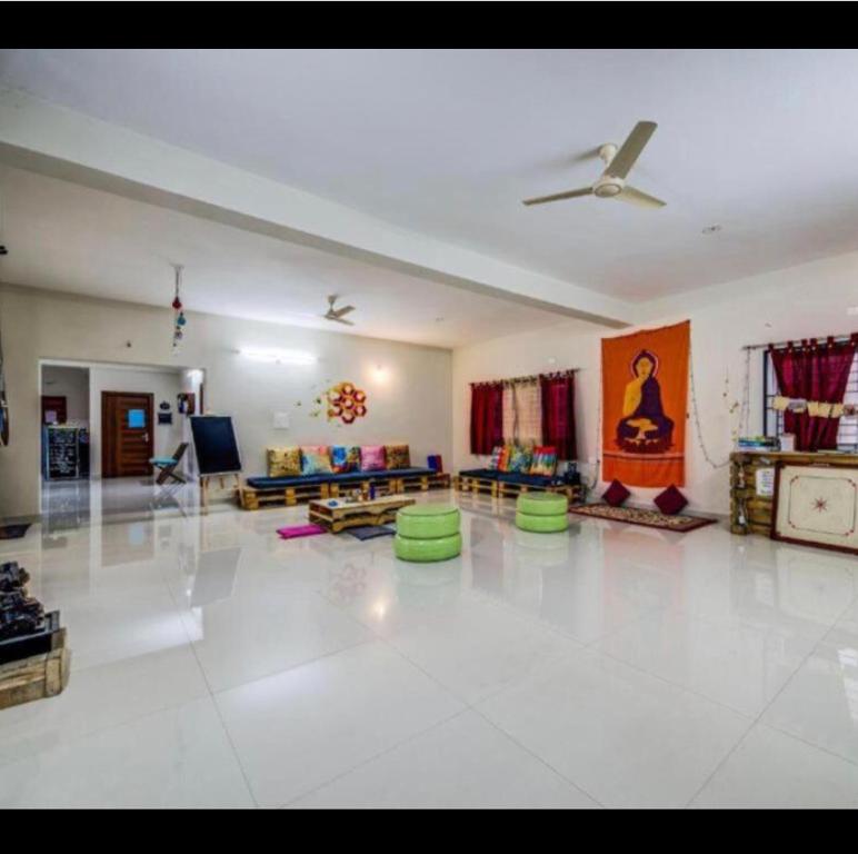 a large living room with green chairs and a ceiling at White Camel companies in Hyderabad
