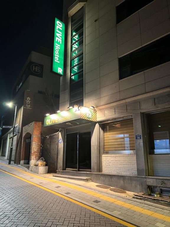 a building with a sign on the side of it at Olive hostel R(Residence) in Seoul