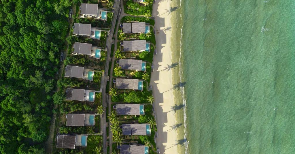 einen Blick über eine Gruppe von Häusern neben dem Strand in der Unterkunft Six Senses Con Dao - Turtle Island Paradise in Con Dao