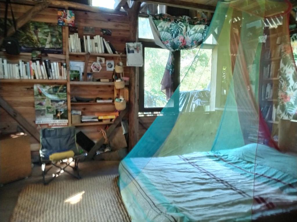 a bedroom with a bed with a net at Ilet Foukènwar in Saint-Louis
