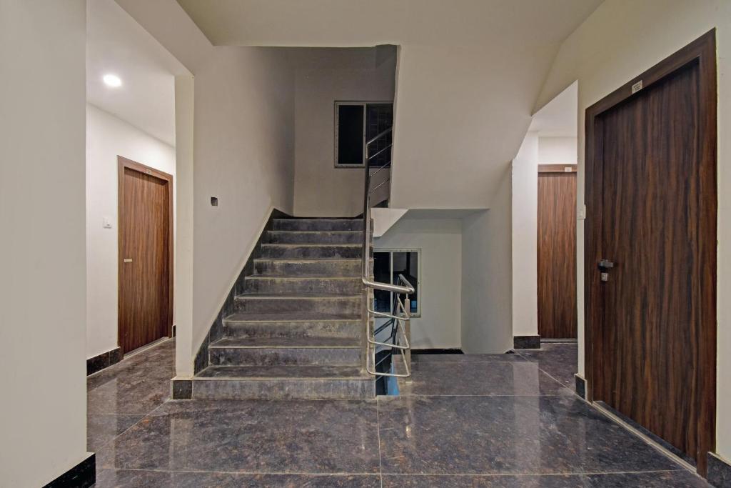 a hallway with a staircase in a house at Flagship Newtown Galaxy in Pānchuria