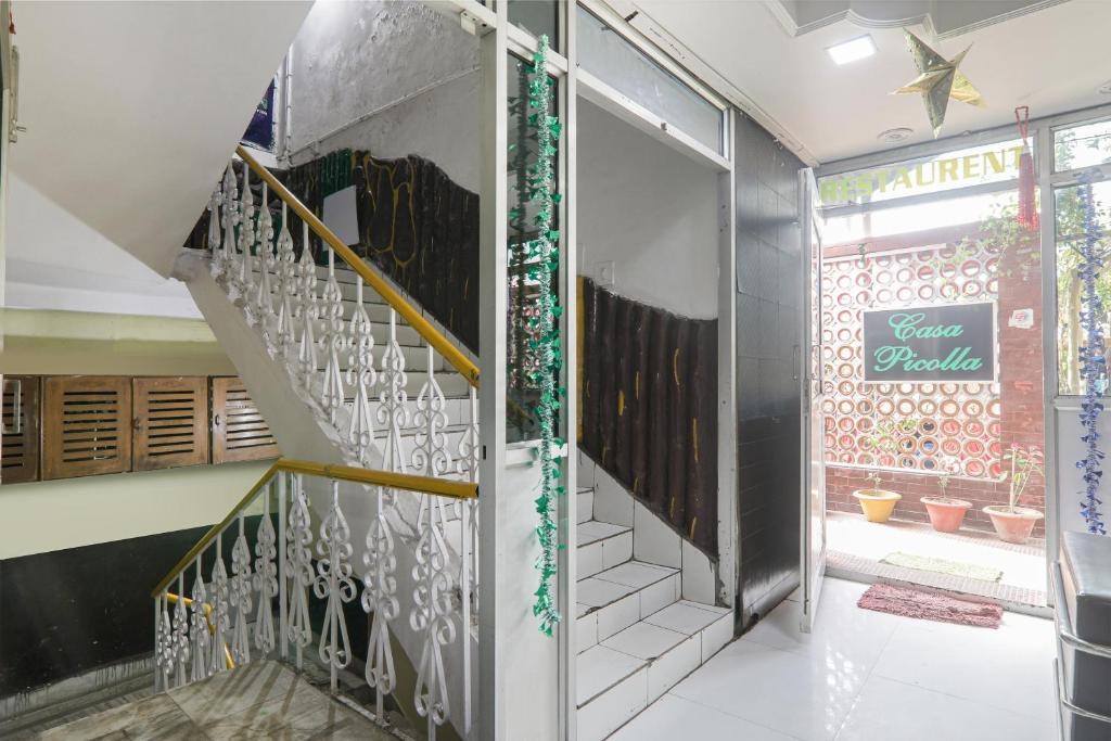 a staircase in a house with a glass entry door at OYO The Casa Picolla in Bankipur