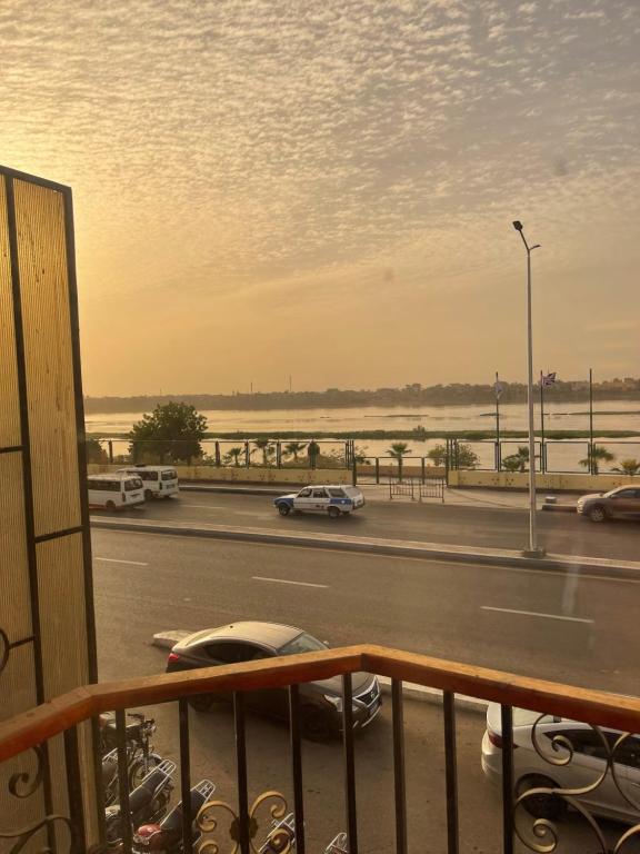 a view from a balcony of a road with cars at Apartment in Luxor Resort, next to Raya Market in Nag` Naqsha