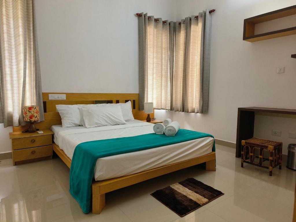 a bedroom with a large bed and a fireplace at Ant Homes by Afrind Hospitality in Cochin