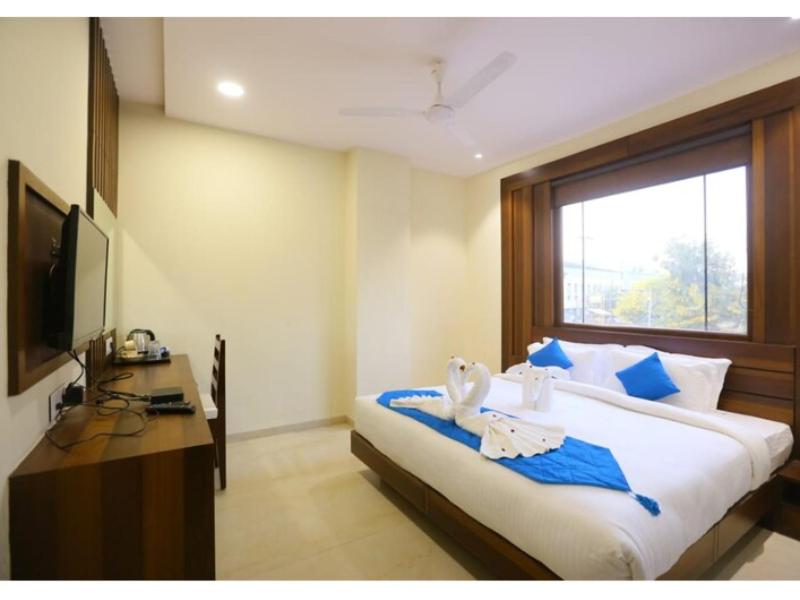 a bedroom with a large bed and a television at Hotel City Star - Agra in Agra