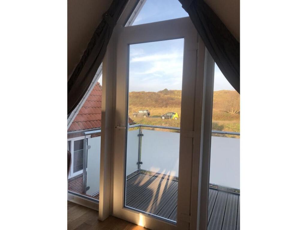 an open window with a view of the water at Torbogenhuus No 5 in Norderney