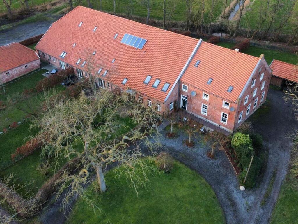an overhead view of a large building with a red roof at Holiday apartment Nordnest in Dornum