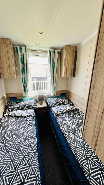 Postel nebo postele na pokoji v ubytování Luxurious caravan in Lyons Holiday Park Rhyl