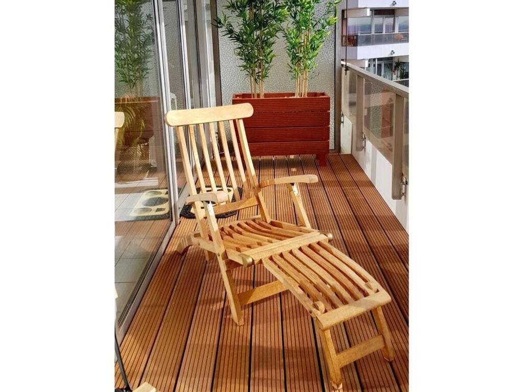 a wooden chair sitting on top of a balcony at Dream view over Cologne in Cologne