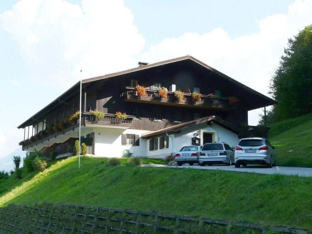 a house with cars parked in front of it at 7 Bergschlössl Modern retreat in Oberaudorf
