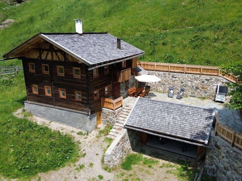 an overhead view of a large wooden house with a patio at Englhof Modern retreat in Corvara in Passiria