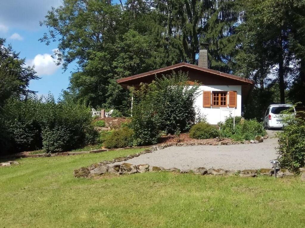 a house in a yard with a gravel driveway at Panorama Comfortable holiday residence in Hilders