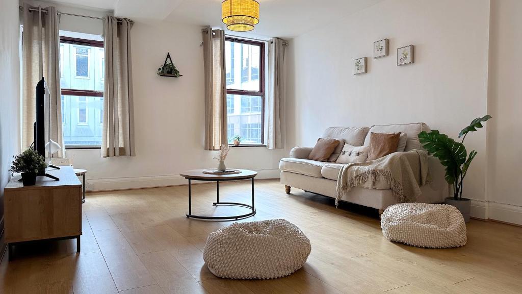 a living room with a couch and a table at City Centre Apartment by Noire Property in Manchester