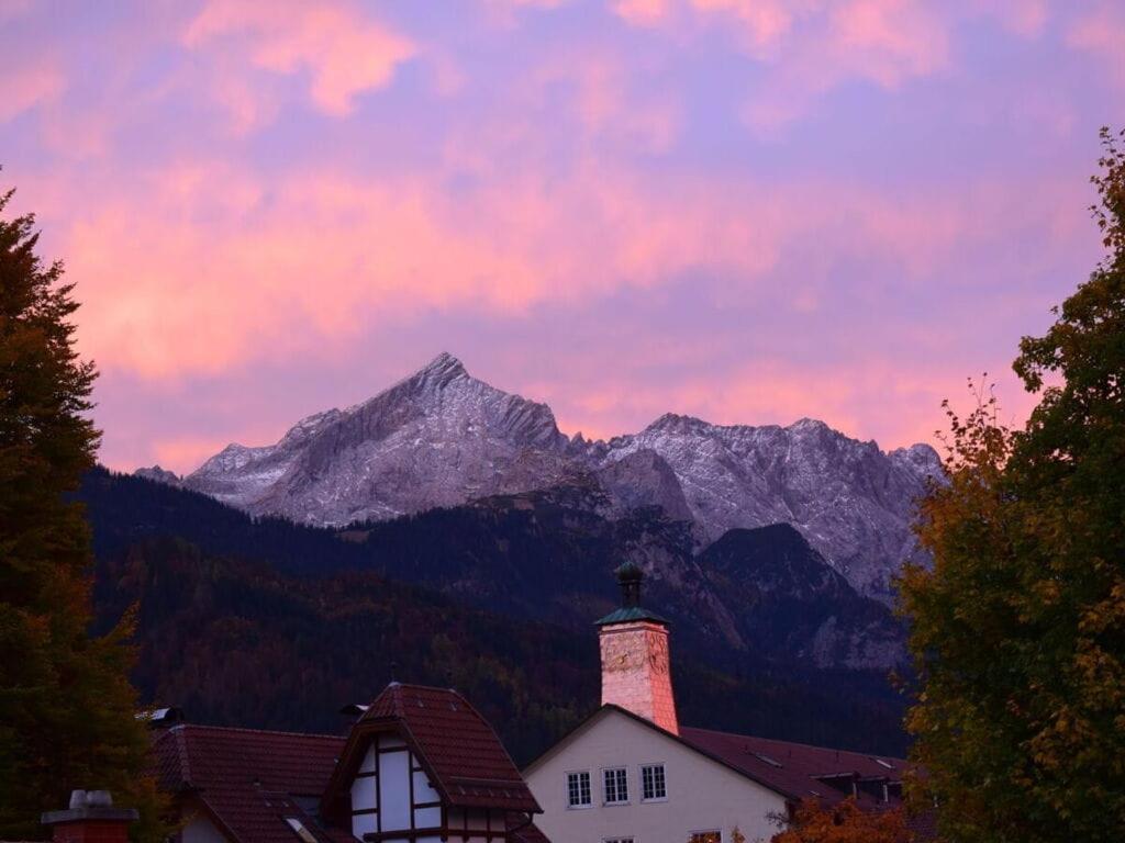 a house with a mountain range in the background at Favorite place 3 in Garmisch-Partenkirchen