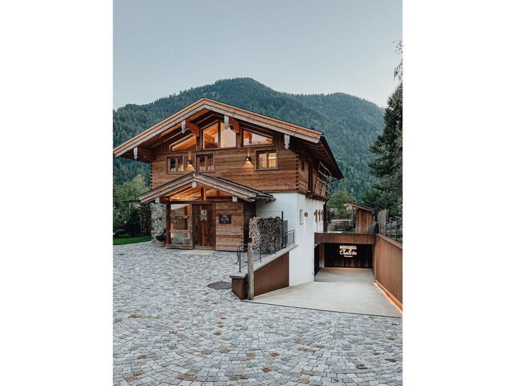 an image of a house with a driveway at Chalet Alpin Modern retreat in Bayrischzell