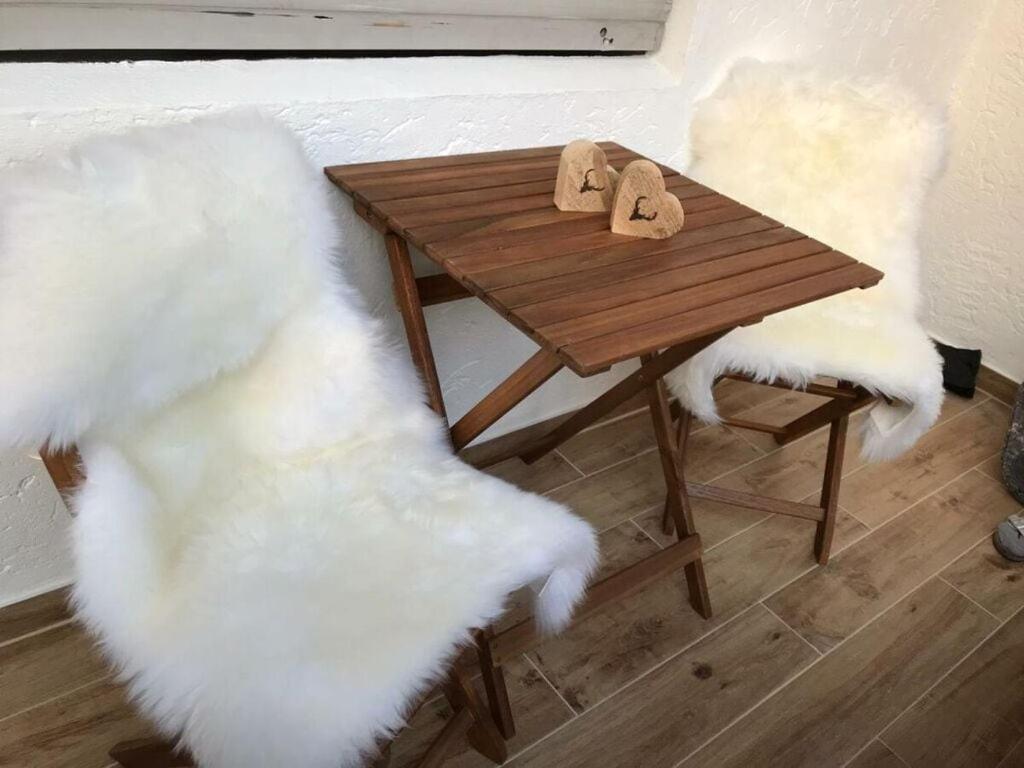 a wooden table with two napkins on top of it at Alpenliebe Modern retreat in Reit im Winkl