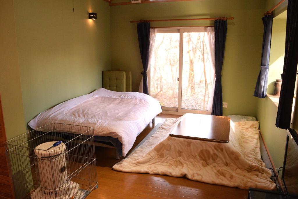 Postel nebo postele na pokoji v ubytování Sasamori House