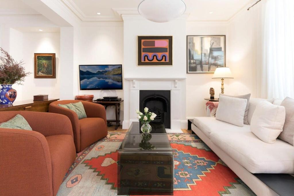 a living room with a couch and a fireplace at Garden Terrace in Surry Hills in Sydney