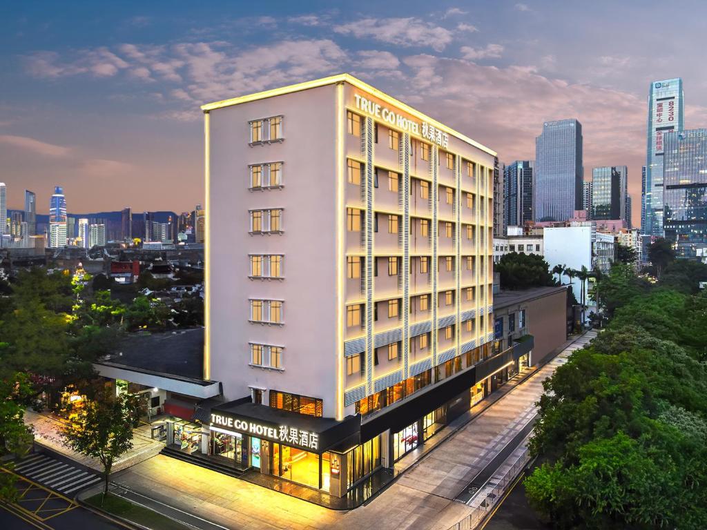 a tall white building with a city in the background at True Go Hotel - Shenzhen Futian Huaqiang North in Shenzhen