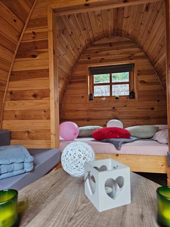 a room with two beds in a wooden cabin at Magnifique Pod avec spa sous bulle privatif in Lanthenay