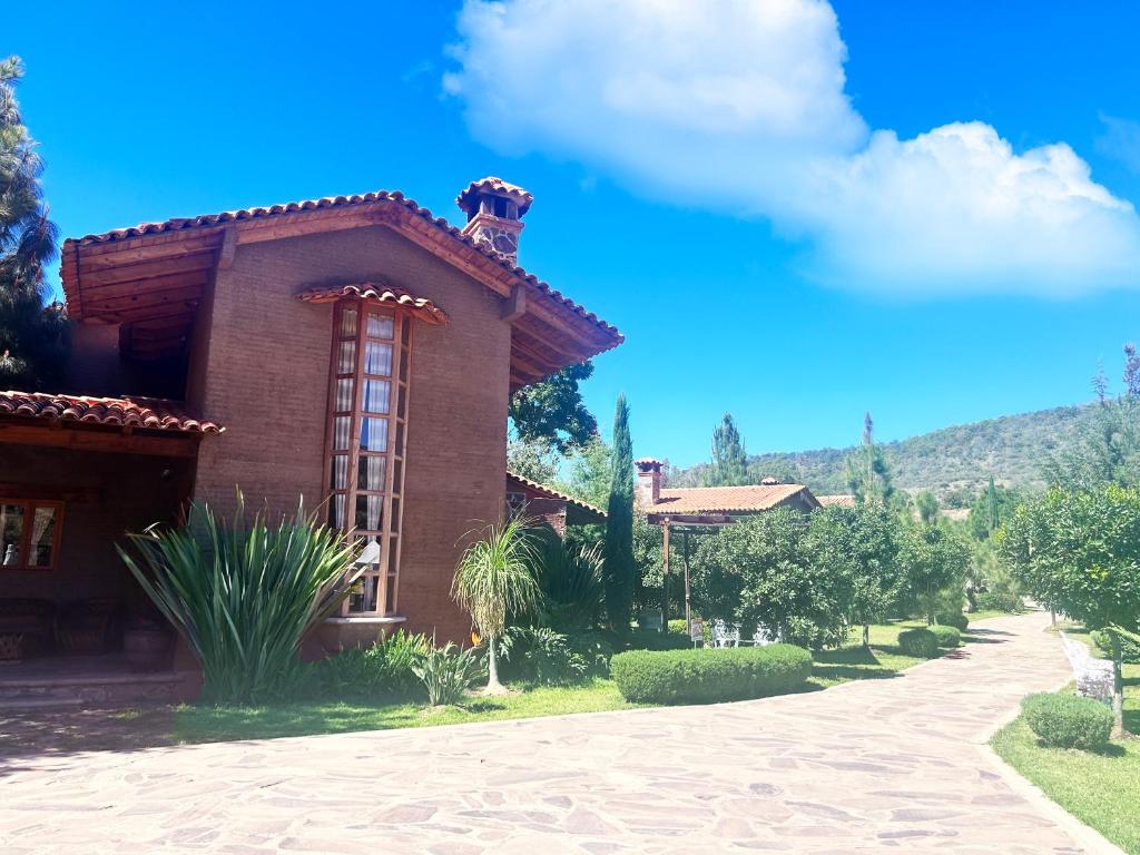 a brown brick house with a blue sky at Hípico Diamante in Tapalpa