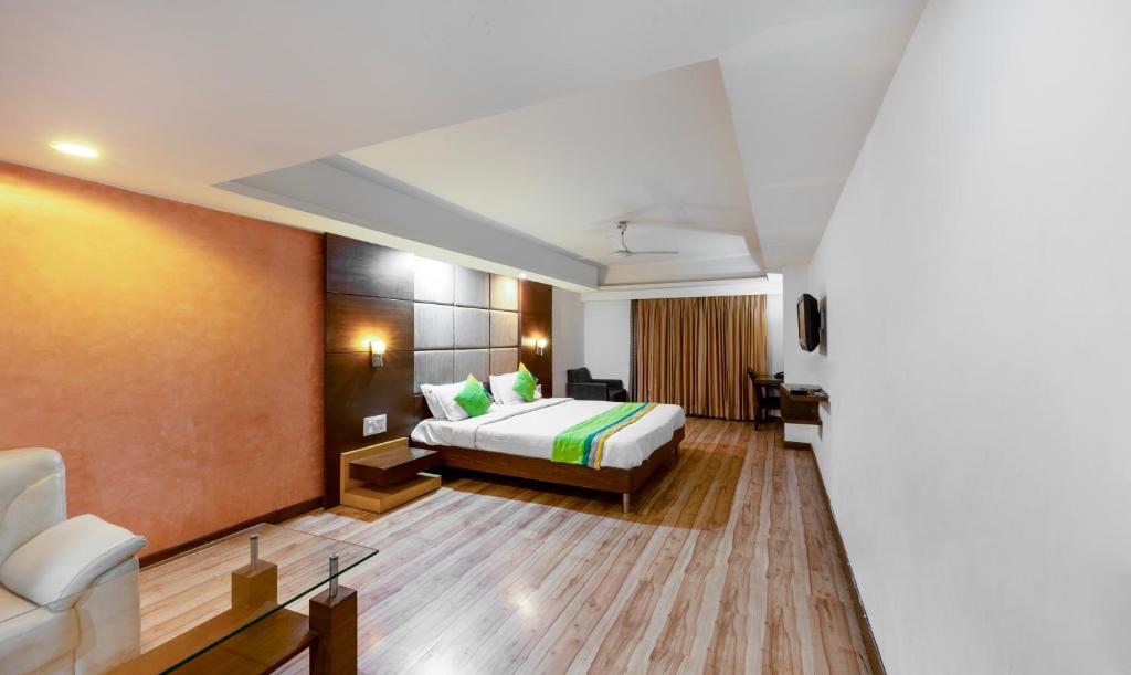 a hotel room with a bed and a couch at Treebo Trend Cambay Sapphire in Ahmedabad