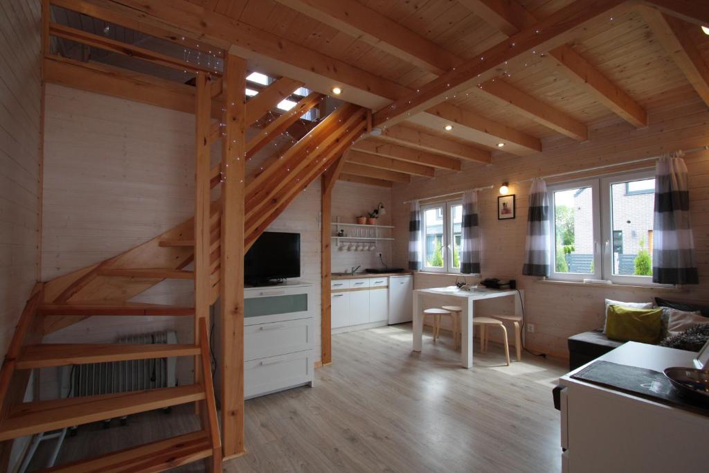een keuken en een woonkamer met een trap in een huis bij Nowabobolin domki in Bobolin
