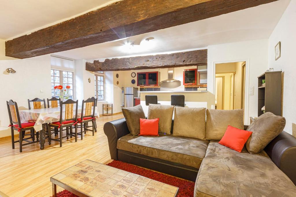 a living room with a couch and a table at Spacieux appartement au cœur de Dinan in Dinan